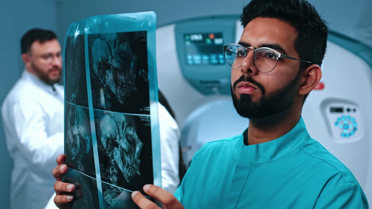 Doctor holding up a medical image to the light